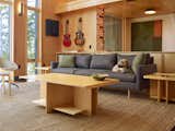 Living Room, Sofa, Coffee Tables, Chair, and End Tables Living room with the architect's guitars hung on the wall (he plays gypsy jazz in his spare time, that's his dog Django on the couch).  Photo 5 of 17 in Willis Point Net Zero House by Will Ragano