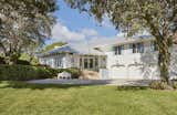 This 1989 home now has bright white exteriors with soft blue shutters and lush bucolic landscapes.