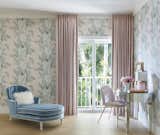 The main bedroom is surrounded with Sanderson’s Calathea wallpaper. In a nook, a Modway chair pulls up to a mirrored desk holding framed vintage botanical prints and a pink quartz Regina Andrew Detroit lamp. The draperies are made of Kravet’s Petticoat material.