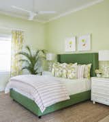 This guest bedroom is designed in shades of green which blends beautifully with the outdoor views.