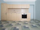 The floor in the kitchen plays with colourful geometric patterns.