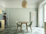 The dining table, which can become a desk when necessary, is placed near the big French windows that open out onto the balcony. 