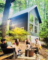 Outdoor, Trees, Side Yard, Stone Patio, Porch, Deck, Shrubs, and Hanging Lighting Side View of The Barn at Edenwood from the outdoor firepit space (photo credit The Hive Drive)  Photo 1 of 35 in The Barn at Edenwood NC by Catherine Morris