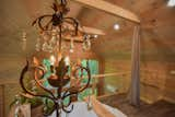 Bath Room, Linoleum Floor, Recessed Lighting, Soaking Tub, Pendant Lighting, and Freestanding Tub The Barn at Edenwood's loft area is an elegant and modern oasis with a mixture of reclaimed pieces (like the antique chandelier) and modern 150 gallon round tub (photo credit Aerial Photo Pros)  Photo 9 of 35 in The Barn at Edenwood NC by Catherine Morris