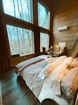 Bedroom, Chair, Bed, Laminate Floor, Accent Lighting, Recessed Lighting, Shelves, and Wall Lighting Side Winter View from the lux bed at The Barn at Edenwood (photo credit The Hive Drive)  Photo 12 of 35 in The Barn at Edenwood NC by Catherine Morris