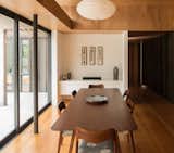 Dining Room, Shelves, Storage, Chair, Bench, Pendant Lighting, Medium Hardwood Floor, Ceiling Lighting, and Table Dining room  Photo 3 of 10 in Peka Peka House II by Herriot Melhuish O'Neill Architects