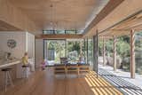 Living Room, Chair, Pendant Lighting, Light Hardwood Floor, Bench, and Stools Living room  Photo 5 of 10 in Peka Peka House II by Herriot Melhuish O'Neill Architects