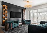 Living Room, Storage, Media Cabinet, Ceiling Lighting, Bookcase, Chair, Medium Hardwood Floor, Sofa, and Accent Lighting  Photo 7 of 8 in Viridescent Speakeasy by Trove Homes