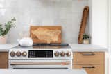 Kitchen, Engineered Quartz Counter, Cooktops, Wood Cabinet, Wall Oven, and Ceramic Tile Backsplashe Riverside Getaway Airbnb kitchen  Photo 12 of 19 in Getaway Motor Café and Riverside Getaway Airbnb by Studio Grey
