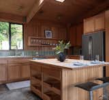 Kitchen, Concrete Counter, Concrete Floor, Ceramic Tile Backsplashe, Refrigerator, Drop In Sink, Wood Counter, Ceiling Lighting, and Wood Cabinet Open kitchen design.   Photo 5 of 10 in The Sea Ranch House at the Airfield by Bill Oxford