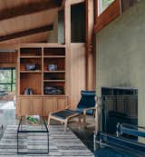 Living Room, Concrete Floor, Coffee Tables, Ceiling Lighting, Gas Burning Fireplace, Standard Layout Fireplace, Chair, and Shelves Living room with classic Sea Ranch style  Photo 4 of 10 in The Sea Ranch House at the Airfield by Bill Oxford