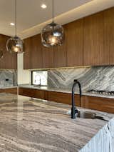 Kitchen, Stone Tile Backsplashe, Wood Cabinet, Pendant Lighting, Ceiling Lighting, Drop In Sink, and Granite Counter  Photo 12 of 15 in Casa Luna by Fred Dionne
