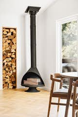 Modern vintage Malm fireplace for a cozy ambiance with decorative wood accent wall.