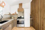 Newly renovated kitchen with farmhouse sink, vintage Smeg refrigerator, gas stove and oven.