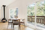 View of living room and dining room with natural sunlight and serene views.