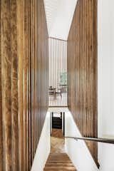 Aesthetic view of the wooden slat design along the stairs and living space.