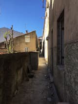 The original exterior view shows the living room window and the entrance via the kitchen on the right.  Photo 6 of 14 in Before & After: In Porto, a Tiny Home Emerges From Ruins