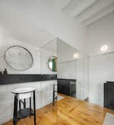 The black beam on the wall was installed to hide the pipes for the sink and bathroom but also doubles as a shelf for soap.