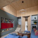 The generous ground-floor living area links to the three bedrooms and mezzanine study via a&nbsp;central staircase. The TV&nbsp;is hidden behind a red glass screen, and the family unfurls a pull-down projector screen for movie nights.&nbsp;