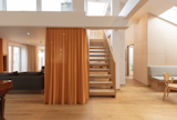 The new wooden staircase is steeper and therefore shorter and, as a result, doesn't create such a large a barrier between kitchen and living room.