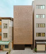 Exterior, Flat RoofLine, House Building Type, and Brick Siding Material Day time facade looking straight on: A private residence in Kaohsiung, Taiwan, with its perforated brick facade being devised by programmatic needs.  Paperfarm Inc’s Saves from The Veil House