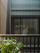 As a common practice throughout Southeast Asia, metallic louvers are often used as means of security for residential architecture. While utilitarian, they are also aesthetically pleasing, creating minimal yet sophisticated light patterns all around.