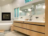 Bath Room, Drop In Sink, Engineered Quartz Counter, Porcelain Tile Floor, Freestanding Tub, and Wall Lighting  Photo 6 of 11 in Linden Hill Remodel: Reimagining Spaces with Timeless Modernity by Loren Wood Builders