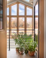 Hallway and Porcelain Tile Floor  Photo 7 of 15 in Serenity in Nature: Wooded View Retreat with a Greenhouse Oasis by Loren Wood Builders