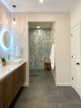 Bath Room, Accent Lighting, Open Shower, Porcelain Tile Floor, Vessel Sink, Full Shower, Engineered Quartz Counter, Ceramic Tile Wall, Ceiling Lighting, Pendant Lighting, and Recessed Lighting  Photo 3 of 7 in Exposed Brick and New Tile Lends a Modern Feel to This Ranch Remodel by Loren Wood Builders