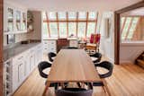 The custom dining table is extendable and was constructed in-house