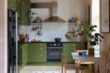 Kitchen, Cooktops, Refrigerator, Dishwasher, Light Hardwood Floor, Microwave, Stone Counter, Subway Tile Backsplashe, Colorful Cabinet, Undermount Sink, and Ceiling Lighting Color Scheme by local KOI Color Studio.  Photo 6 of 11 in Scandinavian Hideaway by Torstein Bjorklund