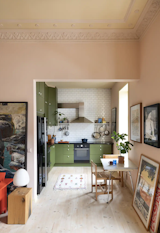 Kitchen, Refrigerator, Stone Counter, Cooktops, Ceiling Lighting, Undermount Sink, Dishwasher, Subway Tile Backsplashe, Microwave, Colorful Cabinet, and Light Hardwood Floor 11 feet ceilings with original plaster details from 1878.  Photo 10 of 11 in Scandinavian Hideaway by Torstein Bjorklund