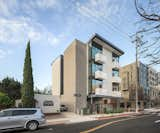 Exterior and Apartment Building Type The party wall side is slotted at the open corridor to introduce light and air through the building while providing unexpected eastward views in a party wall condition.  Photo 3 of 11 in 7th & Robinson by Arlen Hizon