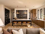 Kitchen open concept to the living room featuring two tones of oak cabinetry and mixed black and brass accents.