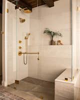 Standing glass shower in ensuite with long ledge and bench seating. 