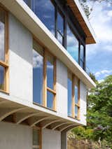 Detail image of the first and second level. Timber and aluminium windows - mixing of materials.