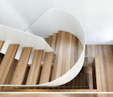  A central steel plate supports the suspended steel stair. The team delivered the curved balustrade - simple line, nice and fine.