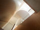 Staircase constructed within a void with natural light invited in through a skylight. Tasmanian Oak and brass detailing.