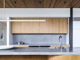 Bespoke kitchen bench combining pre-cast concrete and brass.