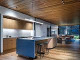 The top floor of Corbel House combines kitchen, dining and lounge - floor to ceiling glass windows surround the space inviting the view in from every angle.
