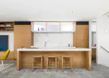 Kitchen with stone island and splashback.