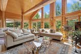 Living Room, End Tables, Chair, Floor Lighting, Sectional, Standard Layout Fireplace, Gas Burning Fireplace, Table Lighting, Ceiling Lighting, Accent Lighting, Coffee Tables, Medium Hardwood Floor, and Sofa Great Room 3  Photo 9 of 32 in Pure Michigan Chalet by Luxury Living International