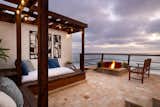 Outdoor, Walkways, Tile Patio, Porch, Deck, Hanging Lighting, Side Yard, and Large Patio, Porch, Deck Ocean view yoga deck with fire pit.   Photo 8 of 13 in Moonstone by Sander Harth