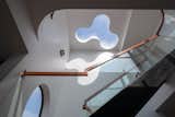 The curvaceous skylight provides abundant natural light from the roof to the ground floor