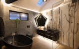 Bathroom Features - Floor to ceiling hand painted acid-etched glass walls. Sculptural Bath and custom designed mirror.