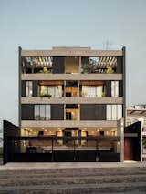 The main facade, with its exposed concrete beams, features a playful design of windows and balconies.