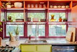 Kitchen, Undermount Sink, Marble Counter, Wood Cabinet, and Colorful Cabinet Morning light comes in through new windows, facing the new back yard.  Photo 1 of 21 in La Croix House by Jennifer Martin