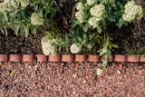 Pink scalloped concrete edgers were used to hold back mulch in planted areas