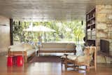 Living Room, Ceiling Lighting, Chair, Sofa, End Tables, Medium Hardwood Floor, Wall Lighting, and Bookcase  Photo 2 of 12 in Casa ML by Play Arquitetura