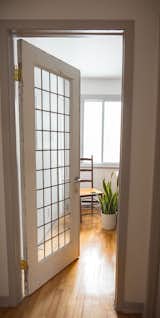 A vintage french door from a former school closes off the home office.